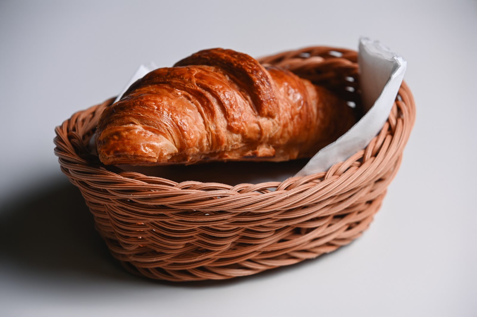 Classic butter croissant in a wicker basket