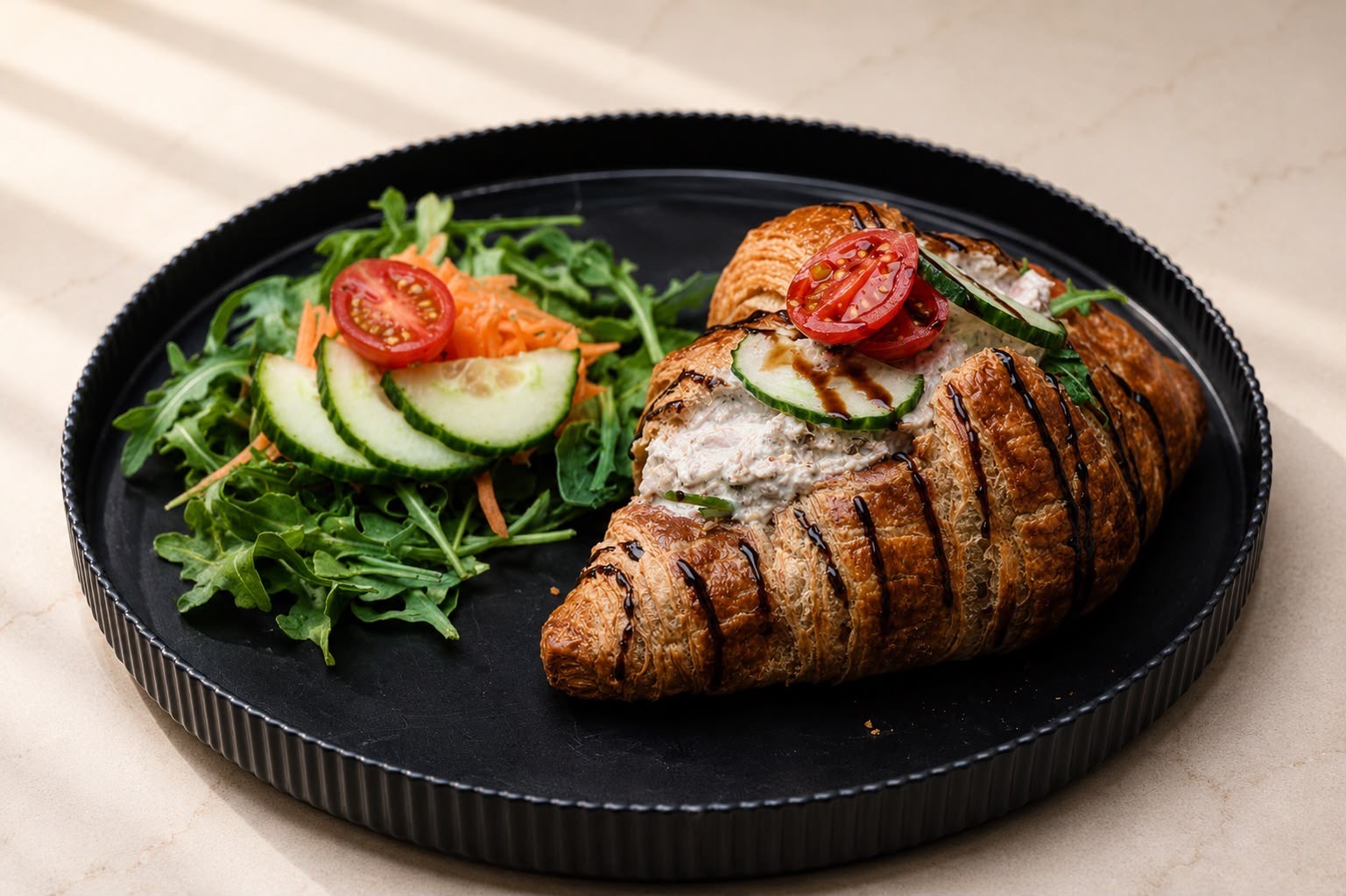 Croissant with tuna salad, cherry tomato, cucumber and balsamic drizzle